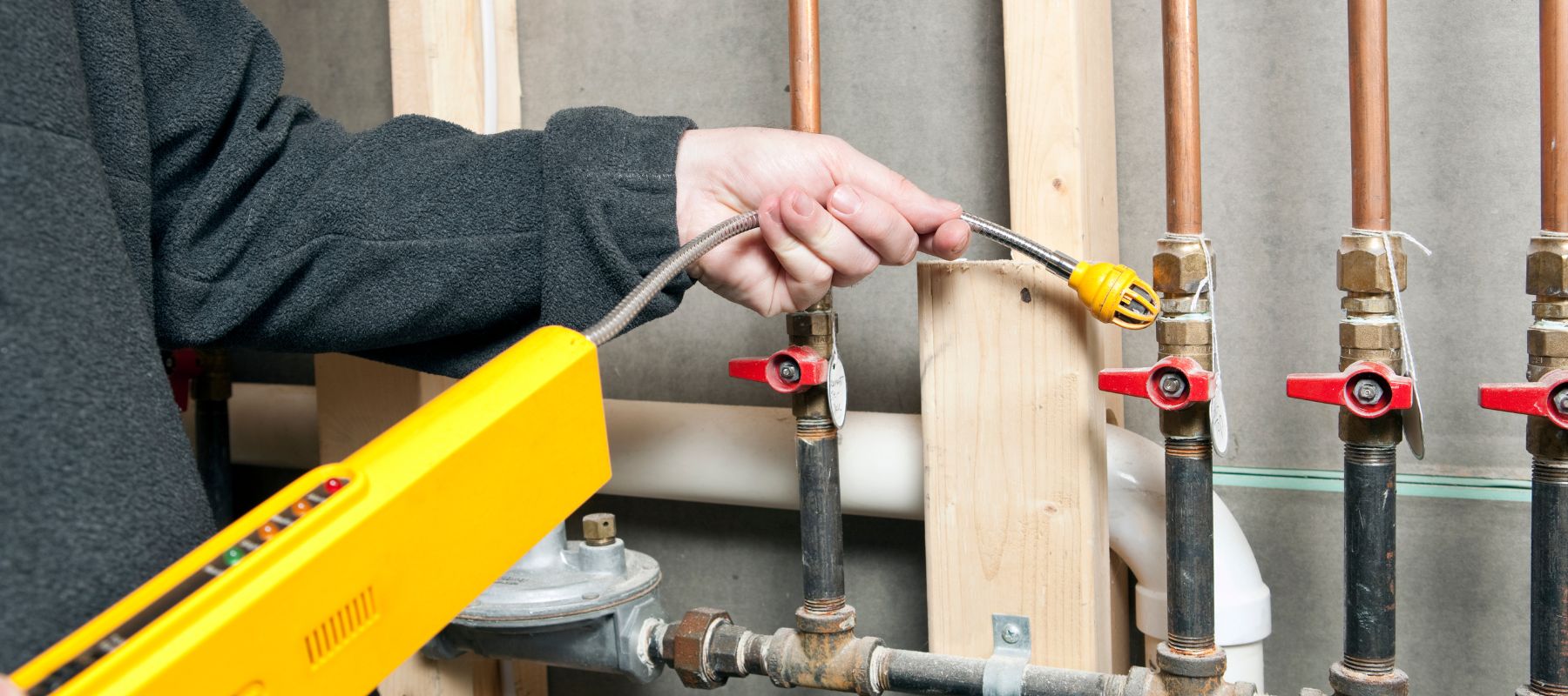 gas line plumber using a tool