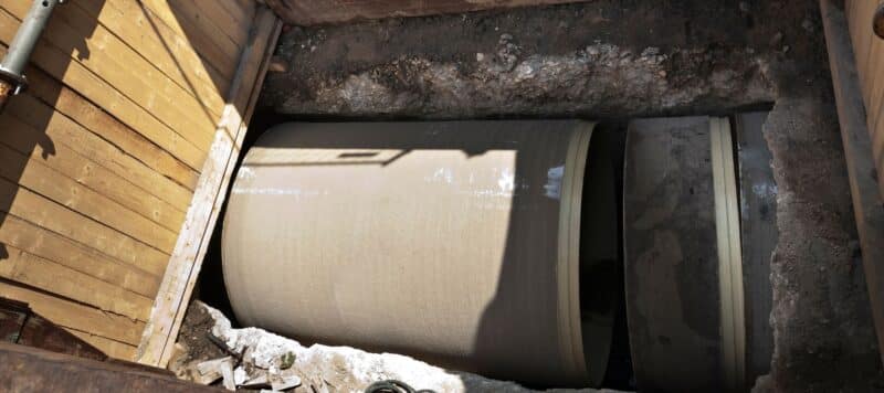 a very large sewer pipe exposed underground